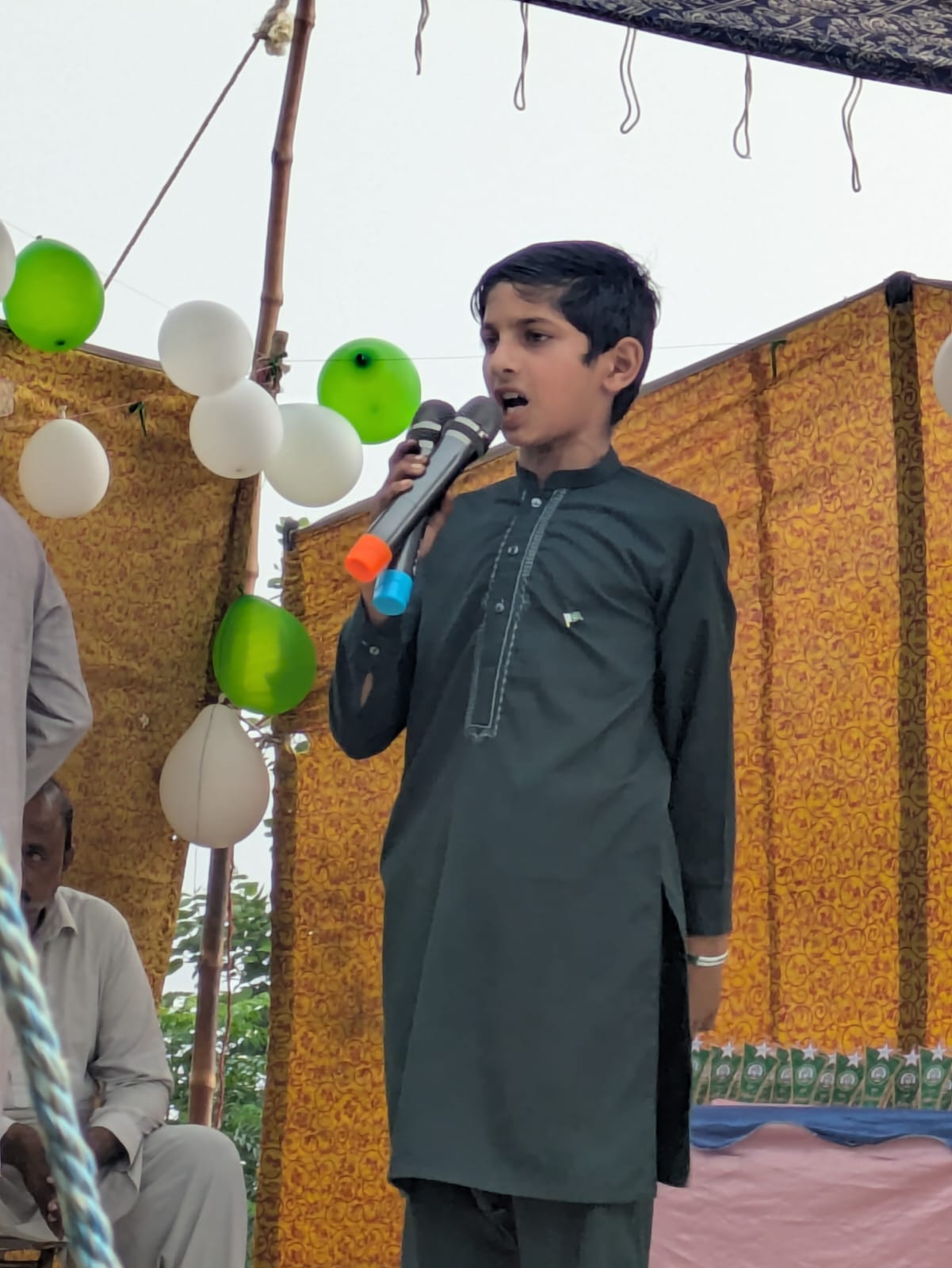 A young performer singing on stage